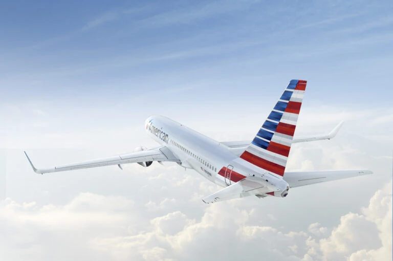 An American Airlines 737 flies above the clouds.