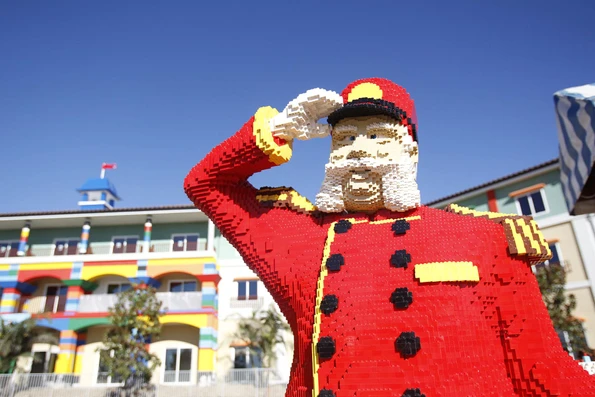 A LEGO bellman stands in front of the LEGOLAND Hotel in California