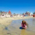 My daughter plays on the beach in front of Hotel del Coronado.