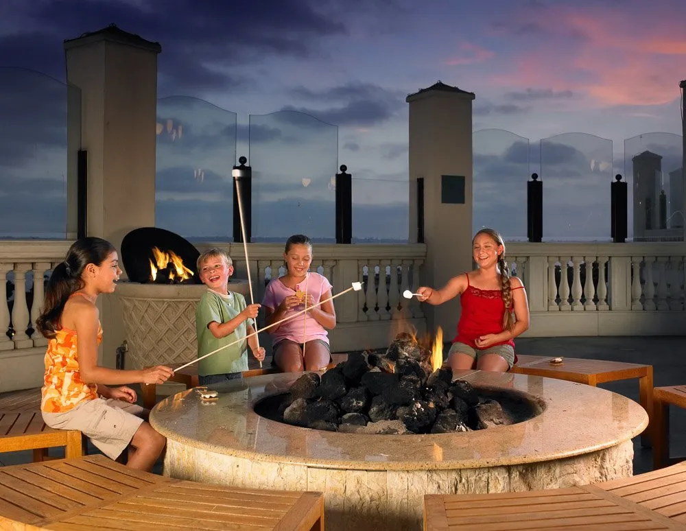 Kids roast s'mores on an outdoor fire pit at Manchester Grand Hyatt San Diego.