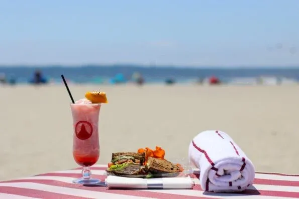 Drink towel and sandwich on a chair at Del Beach in Coronado.