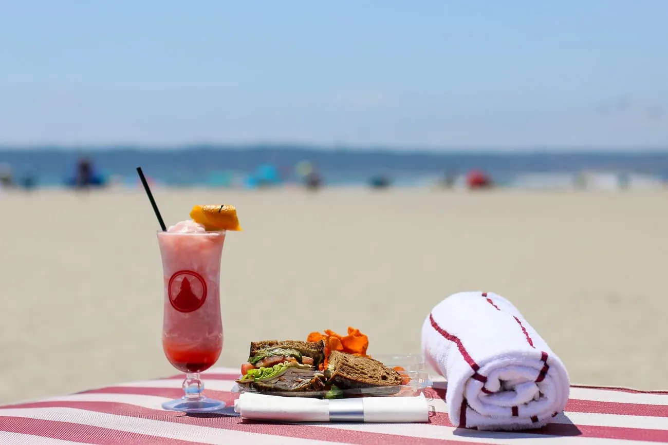 Drink towel and sandwich on a chair at Del Beach in Coronado.