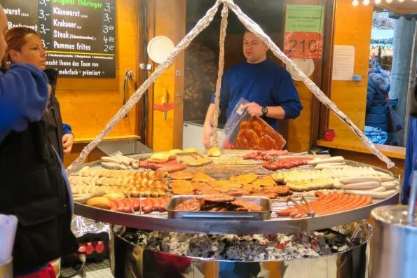 Bratwurst and other meats on the grill at the Frankfurt Christmas Market