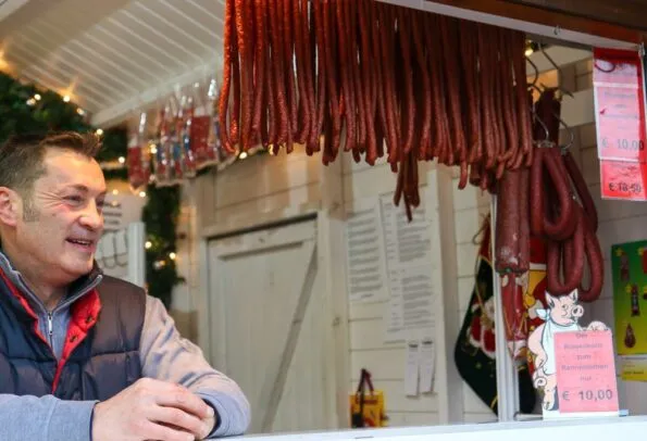 Frankfurt Christmas Market Dried Sausage hangs from a stall.