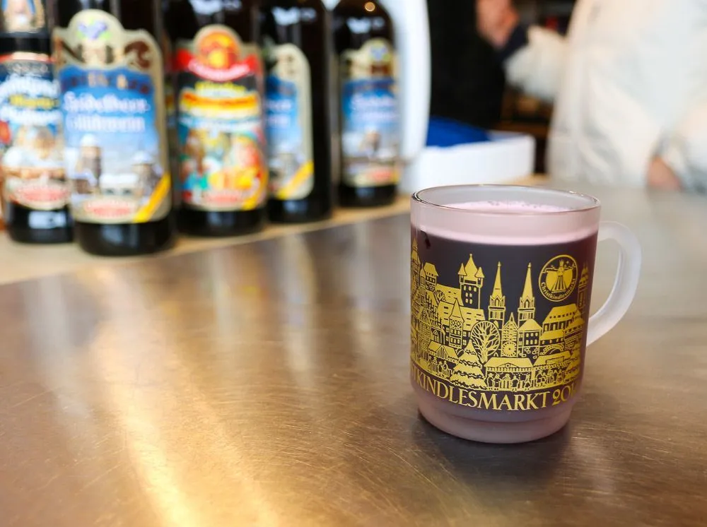 Drink gluhwein at the Nuremberg Christmas Market to warm up! Take the glass home as a souvenir.