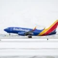 A Southwest Airlines plane takes off on a snowy day.