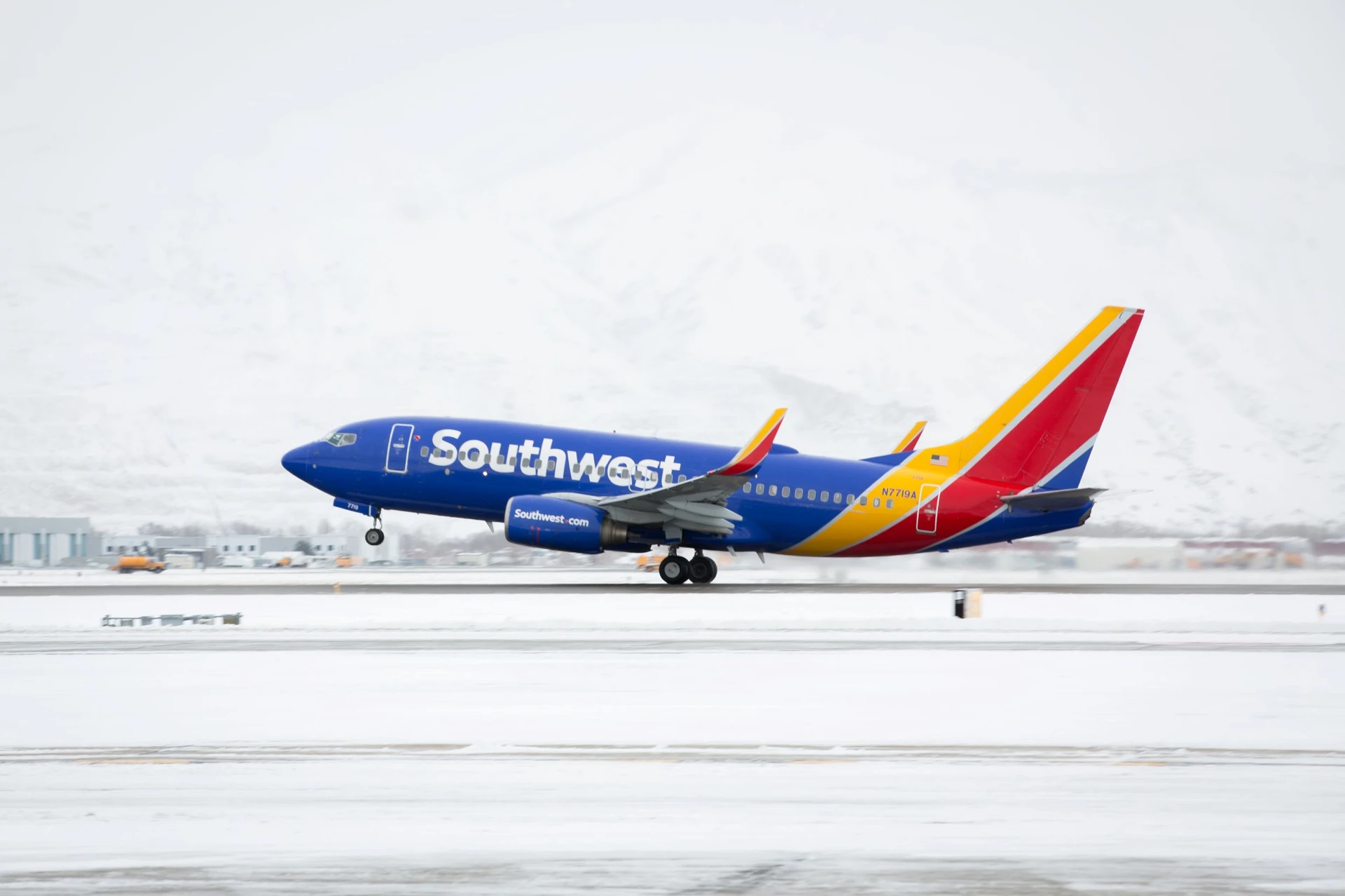 A Southwest Airlines plane takes off on a snowy day.
