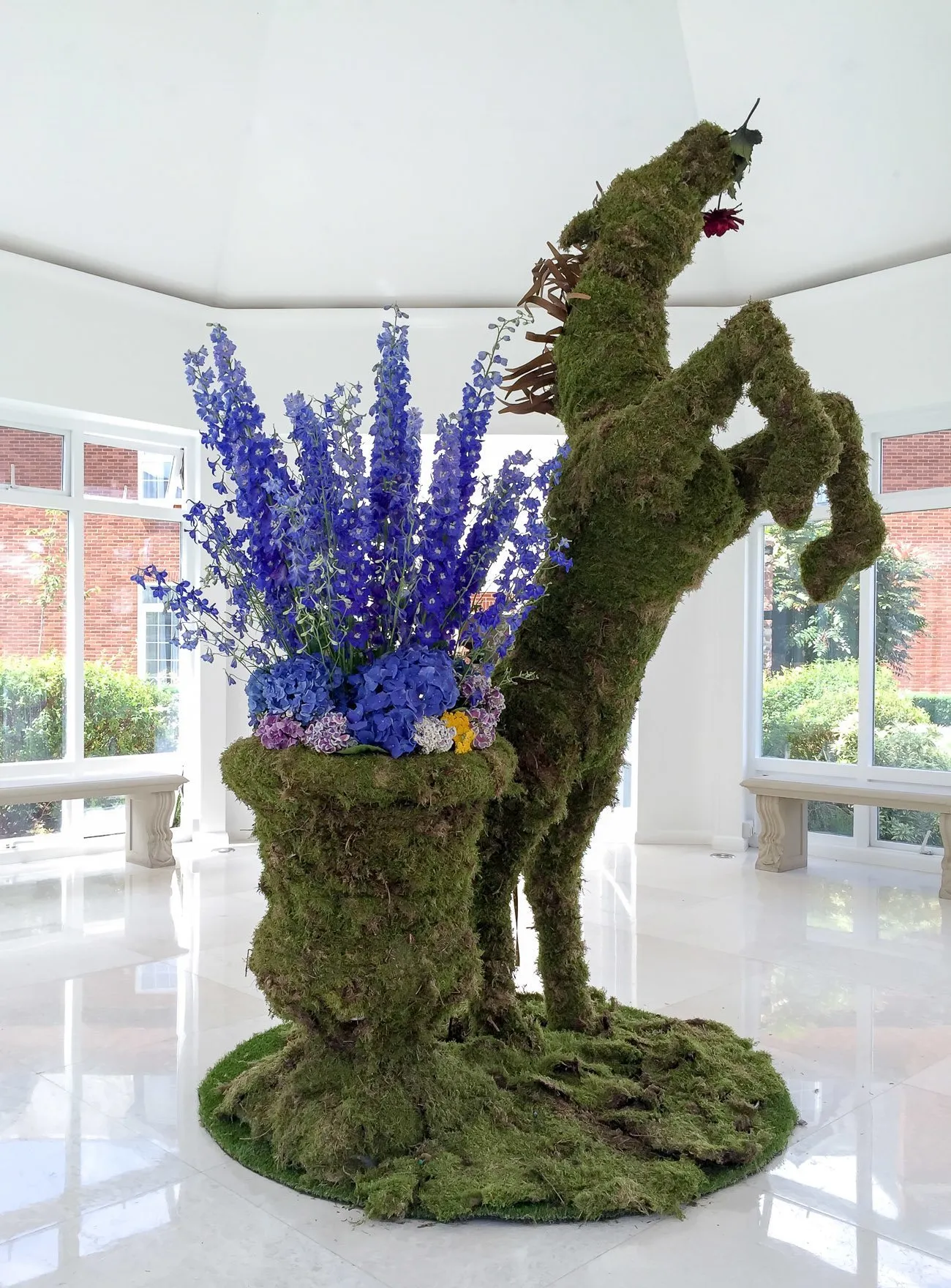 An equestrian topiary with purple flowers at Four Seasons Hotel Hampshire, England