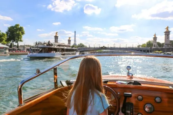 My daughter briefly drove the River Limousine boat down the Seine in Paris