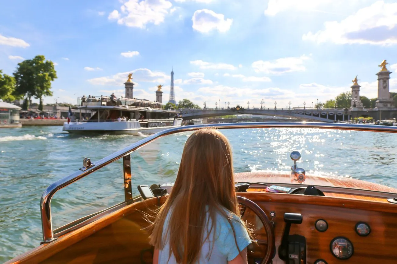 My daughter briefly drove the River Limousine boat down the Seine in Paris