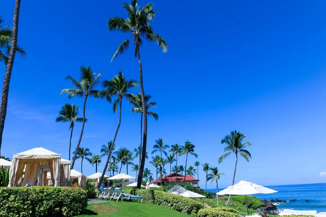 Cabanas near the beach at Four Seasons Maui at Wailea, a family-friendly vacation option.