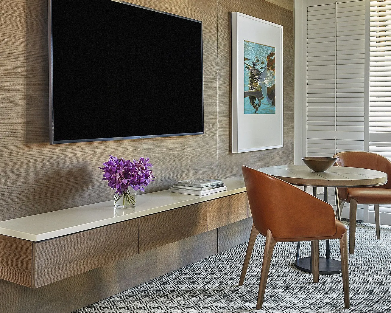 A sitting area and TV inside a newly-renovated room at Four Seasons Resort Maui at Wailea.