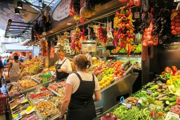 Vendors selling fruit at La Boqueria Market in Barcelona