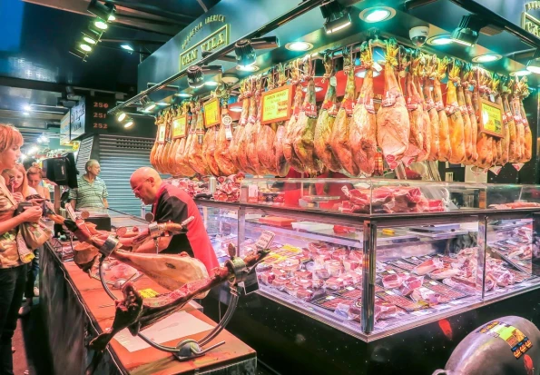 A meat vendor in La Boqueria Market in Barcelona.
