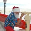 San Diego's Surfin' Santa looks through a telescope over the bay at Seaport Village.