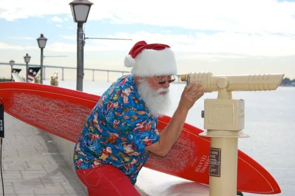 San Diego's Surfin' Santa looks through a telescope over the bay at Seaport Village.