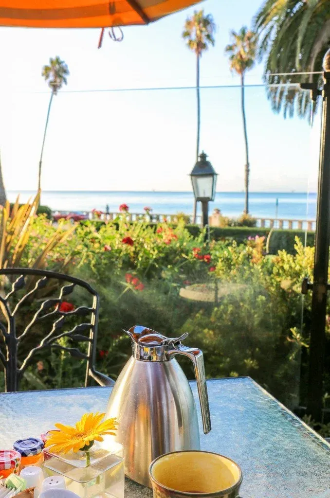 Coffee pot on an outdoor table with a view out to the ocean