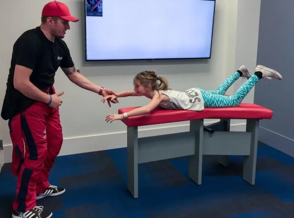 Before indoor skydiving at iFly in San Diego, an instructor walks you through basic hand signals and proper formation.
