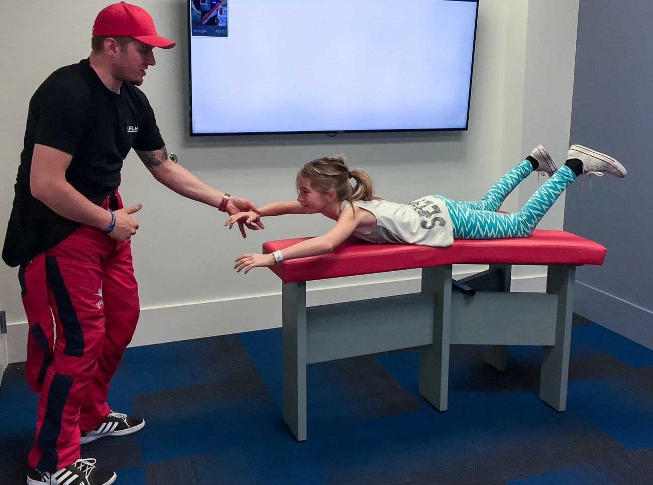 Before indoor skydiving at iFly in San Diego, an instructor walks you through basic hand signals and proper formation.