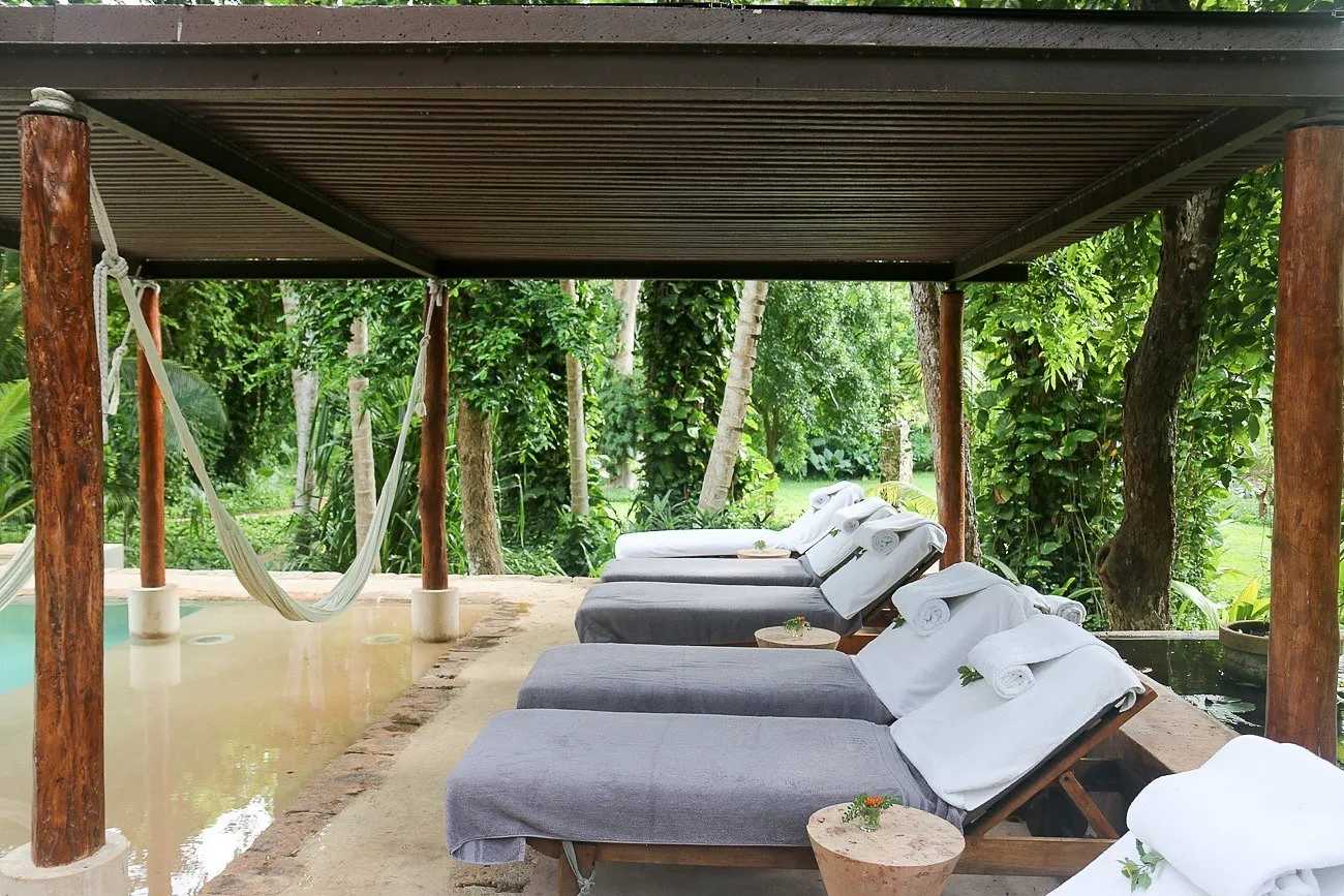 Chairs and hammocks near the pool at Hacienda Petac near Merida, Mexico.
