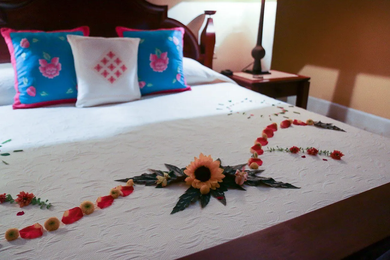 Flowers on a bed ready for guest arrival to Hacienda Petac in Merida, Mexico