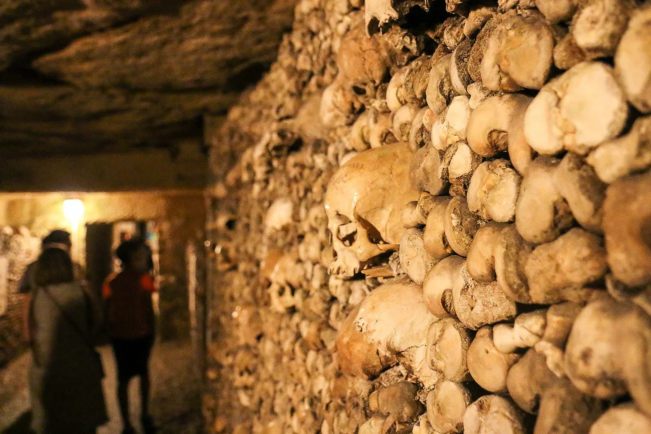 People touring the Paris Catacombs, a popular attraction.