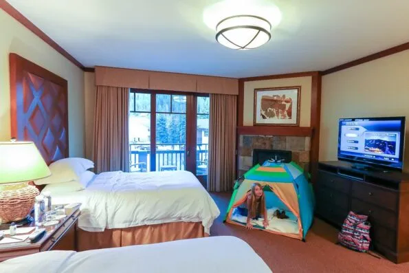 A room at Four Seasons Resort Vail with a tent for kids and a fireplace!
