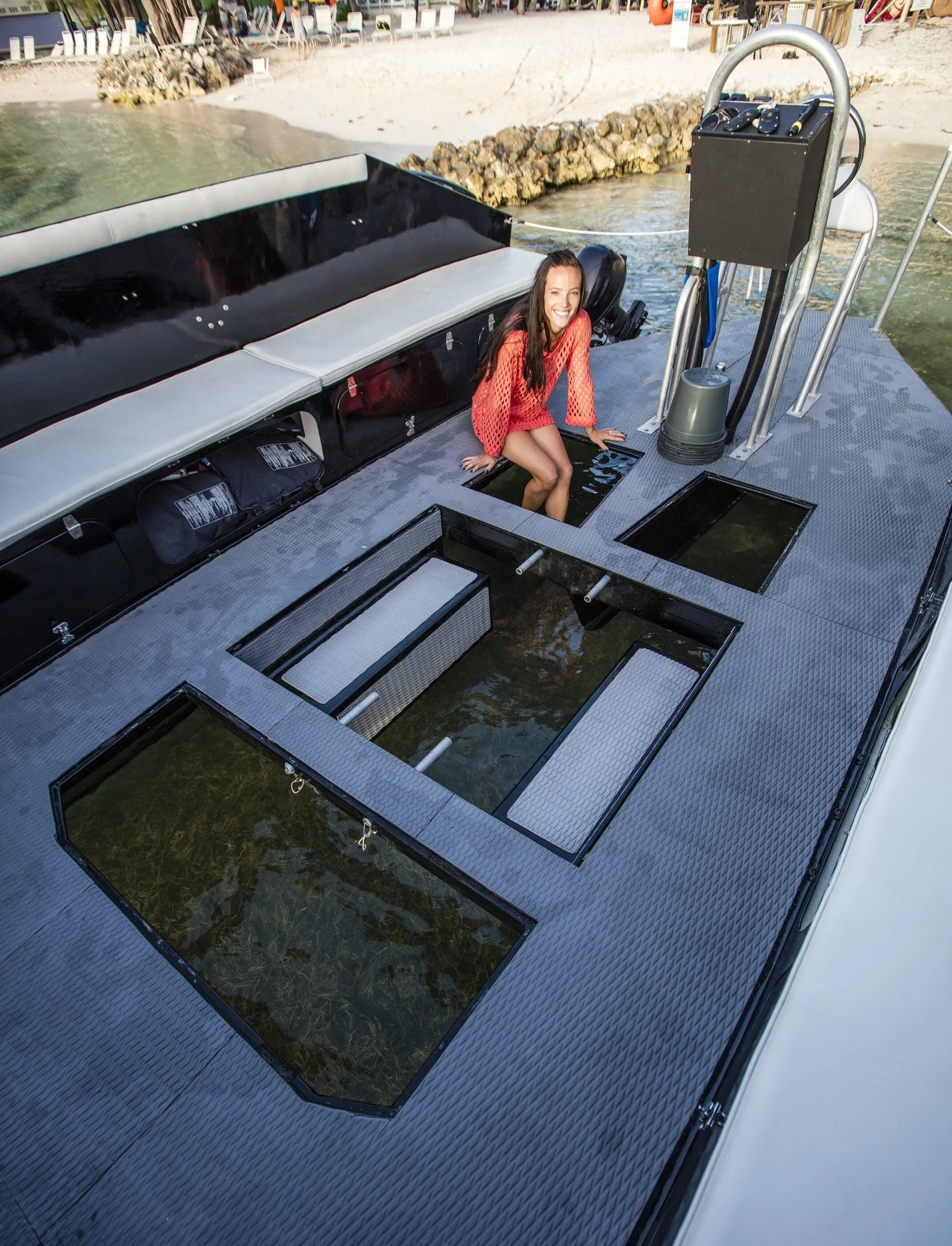 The boat with open bottom in daylight showing how guests can interact with the organisms.