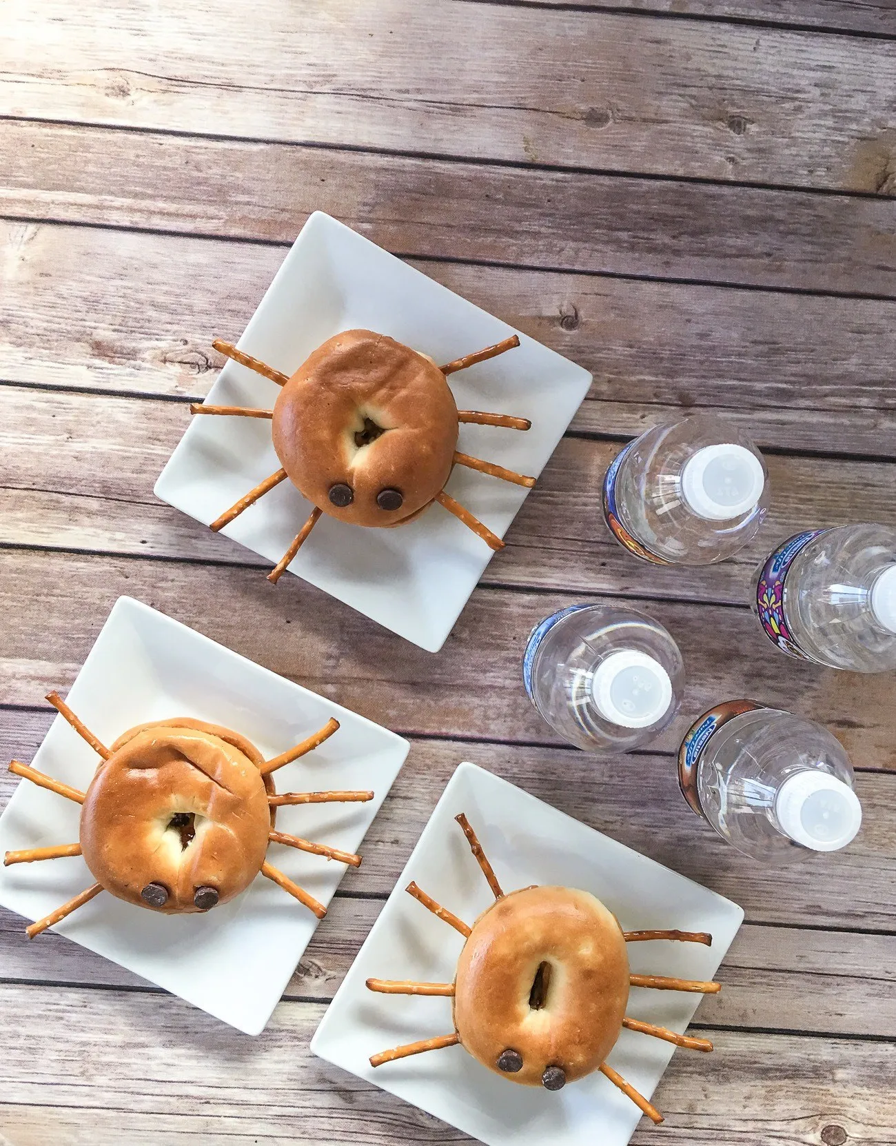 Make easy peanut butter and jelly spider mini bagels.