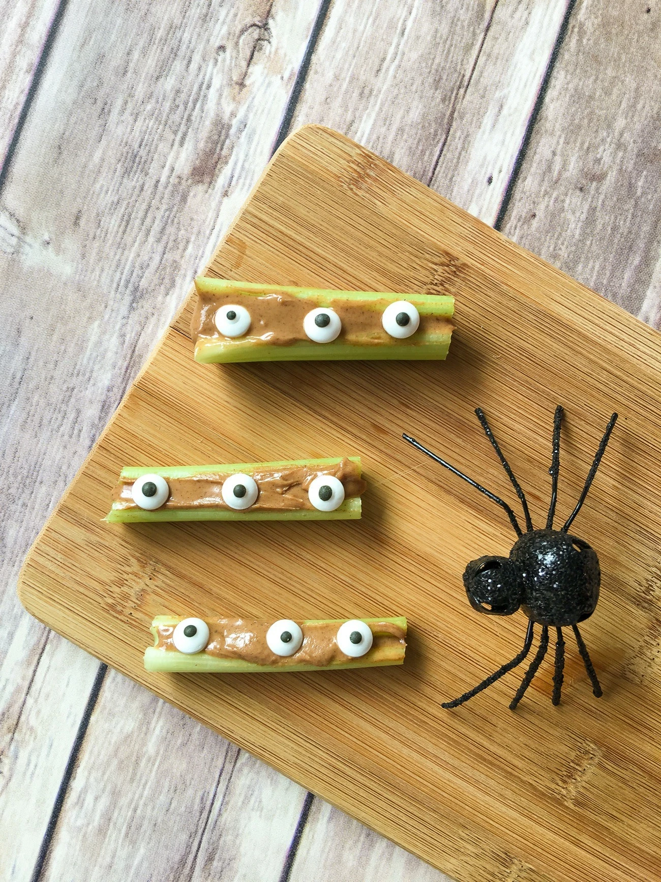 Celery filled with almond butter and topped with candy eyeballs.