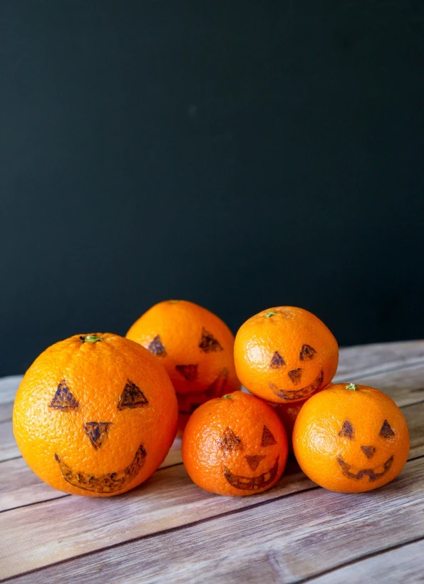 Draw jack-o-lanterns on oranges and tangerines with food safe markers for an easy Halloween snack.