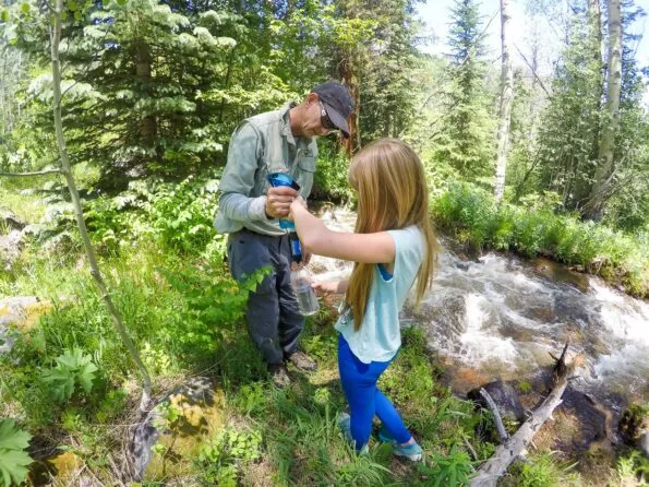 Learning how to filter water on a llama trek with Paragon Guides.