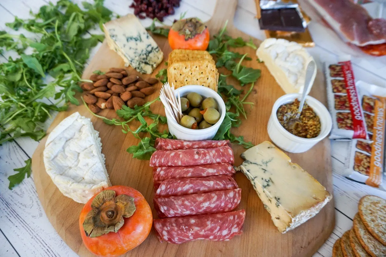 Start assembling your charcuterie and cheese platter from the center and move outward.