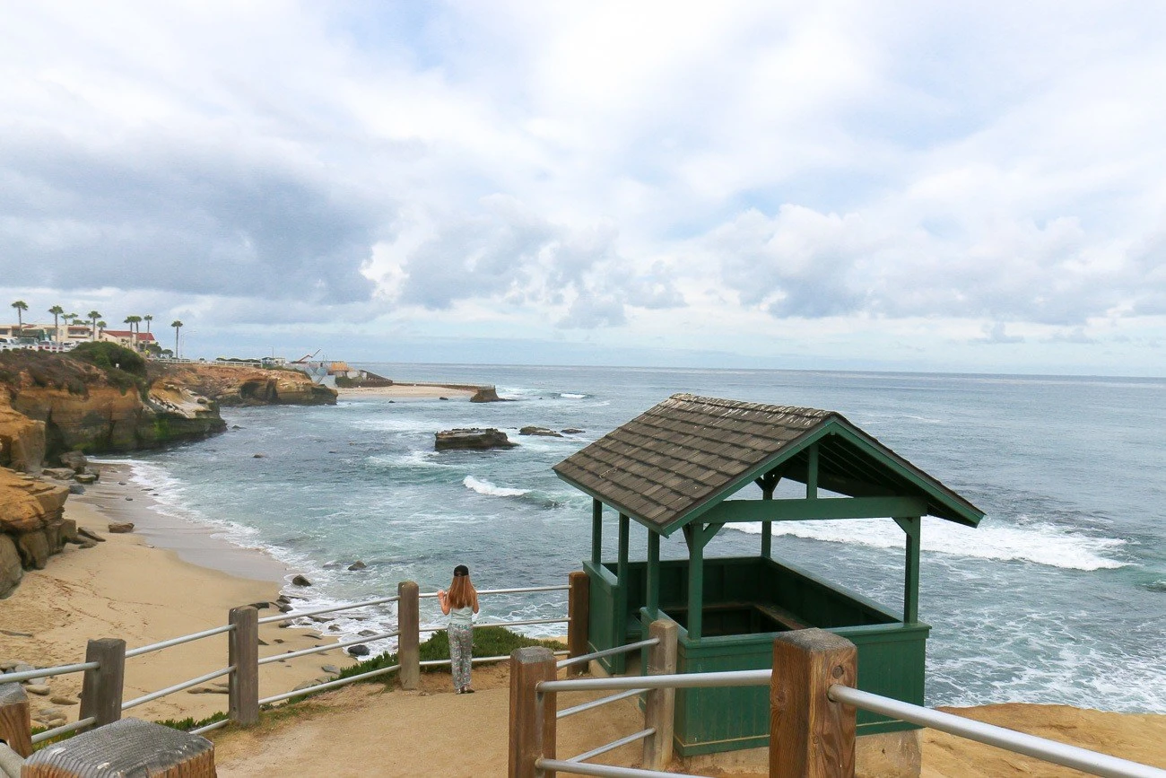 My daughter looks from the upper railing down to Shell Beach.