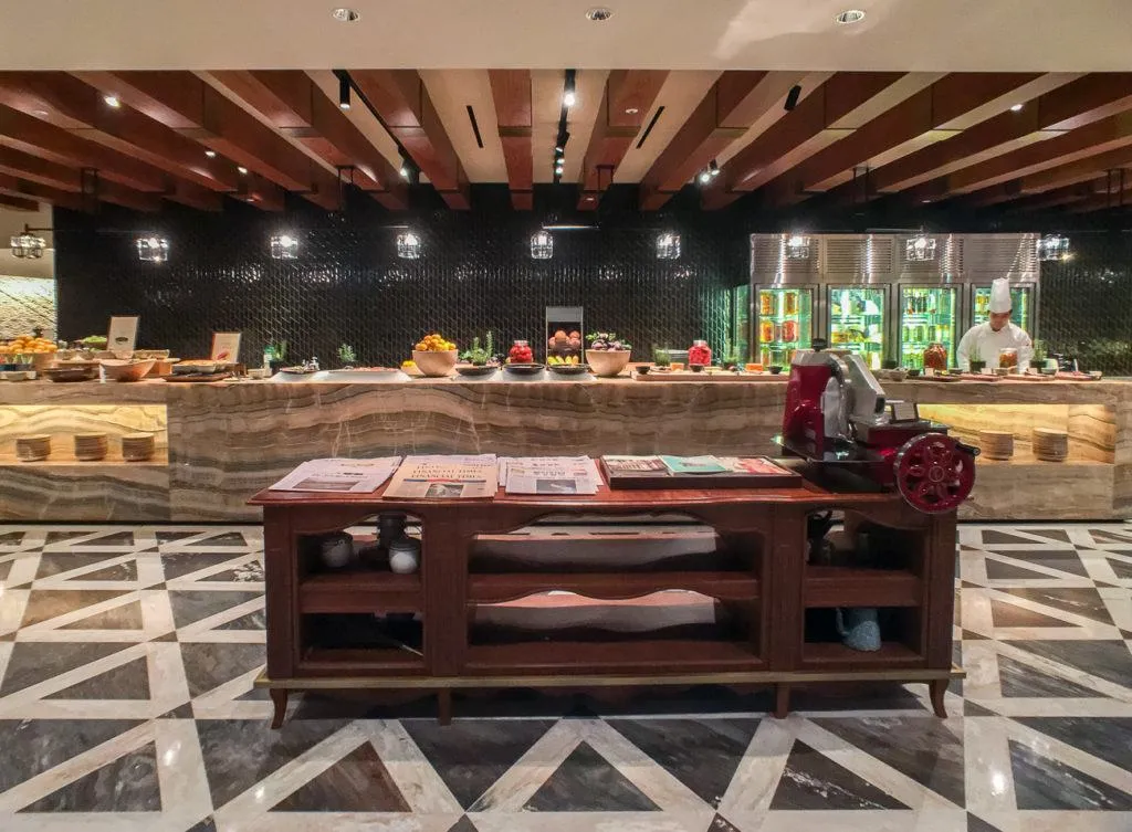 Chefs prepare food in open kitchens at Four Seasons Hotel Seoul's buffet restaurant, The Marketplace.