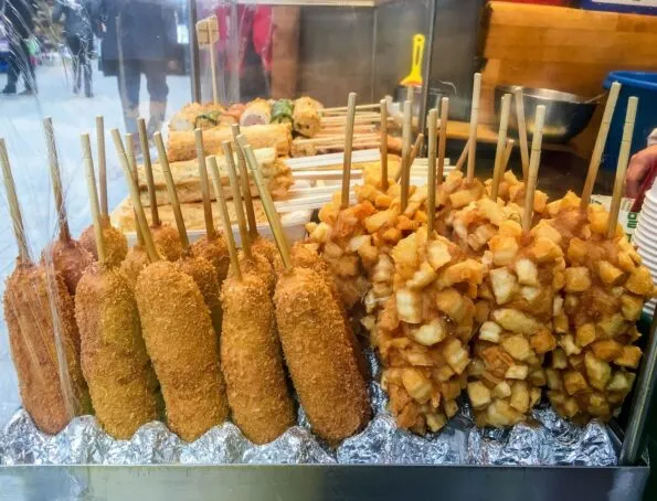 French fry covered corn dogs are a popular street food in Seoul.