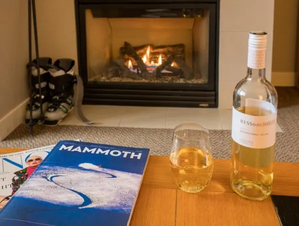 Resting by the fire after a long day of skiing at The Westin Monache Resort, Mammoth with wine from a Bleu Market and Wine Bar basket.