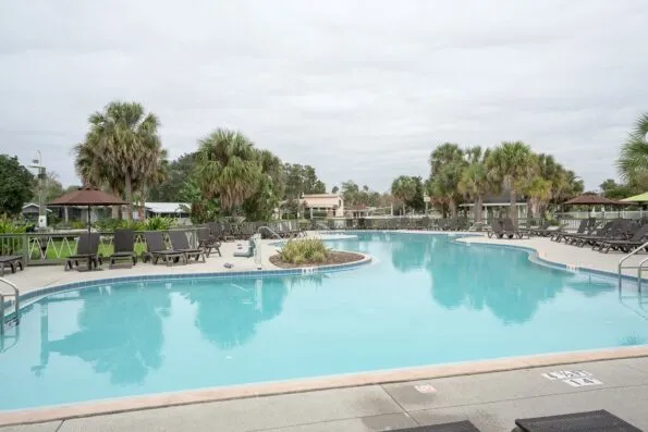 The large swimming pool area surrounded by lounge chairs.
