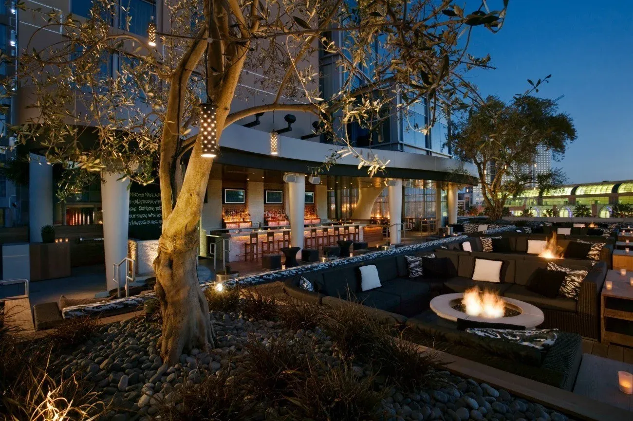 Hard Rock San Diego outdoor lounge and bar seating areas after sunset.