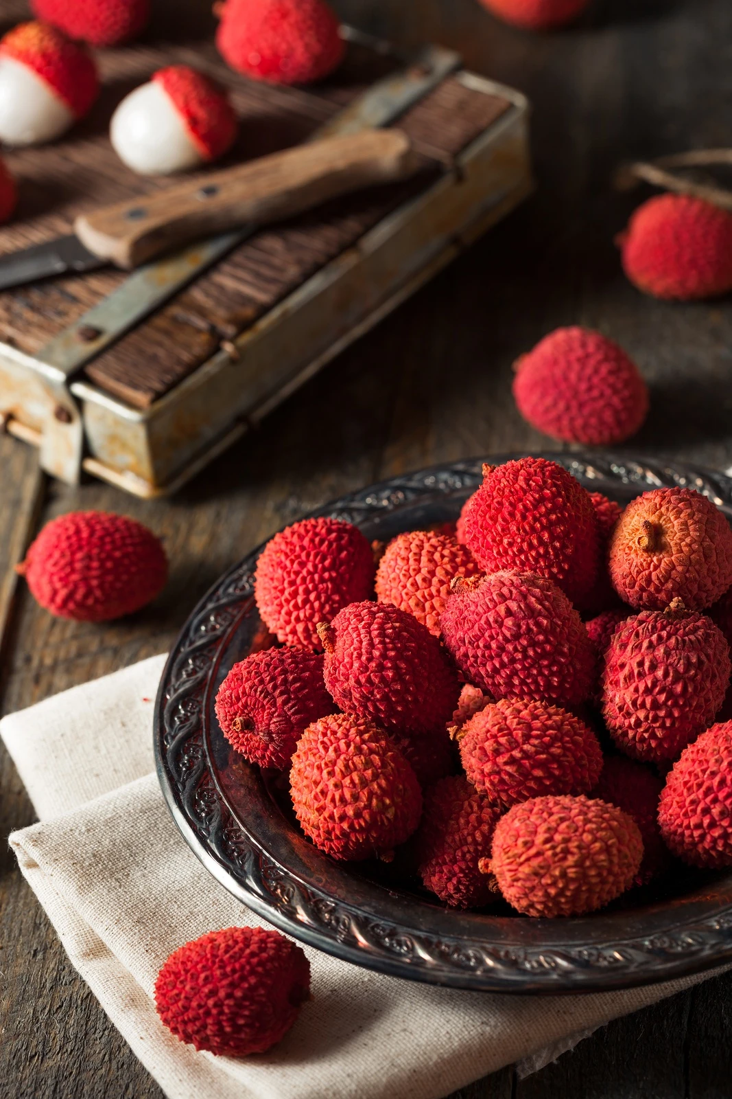 Unpeeled lychee in a bowl, a popular Chinese fruit.