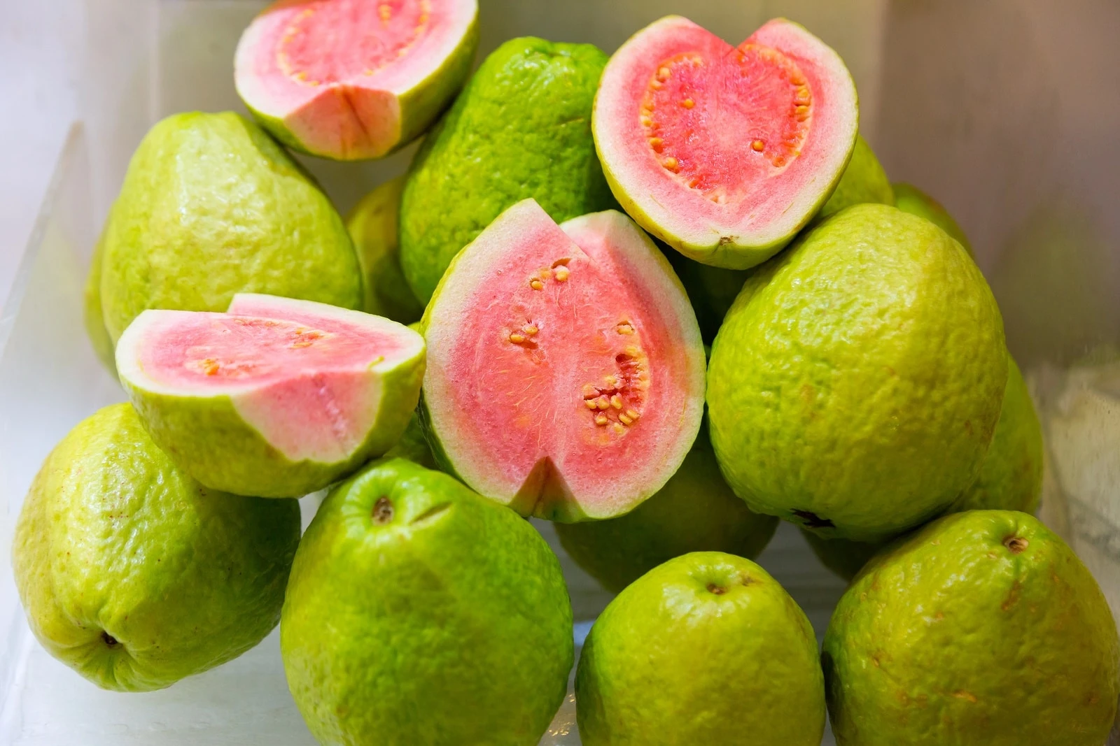 Large Asian guavas whole and cut in half.