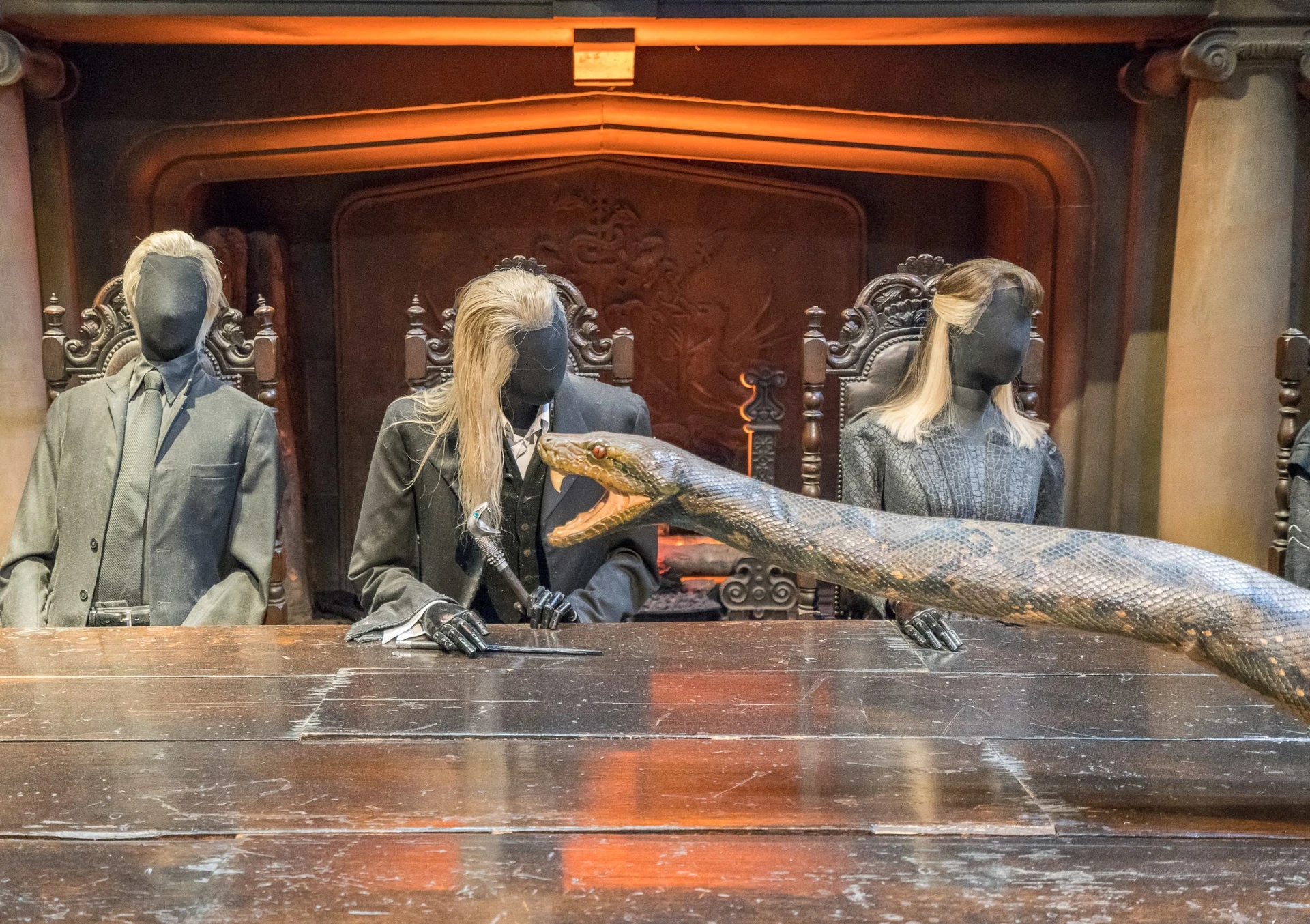 A scene in a Harry Potter movie where Nagini the snake crawls on the table, reenacted at the Warner Bros. Studio Tour London.