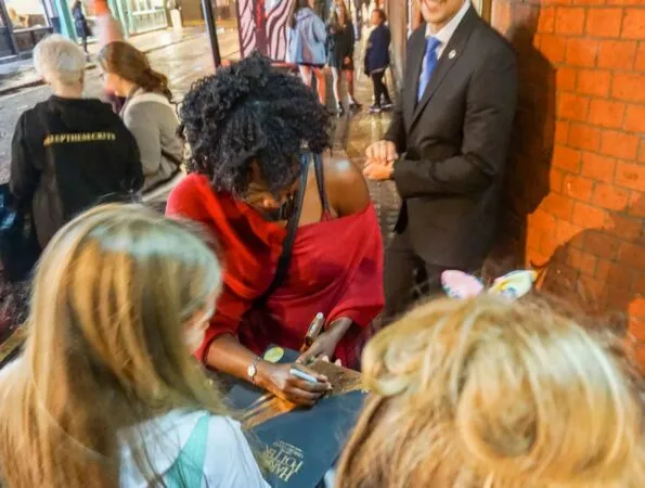 Actors sign autographs near the backstage door of the Cursed Child play in London.