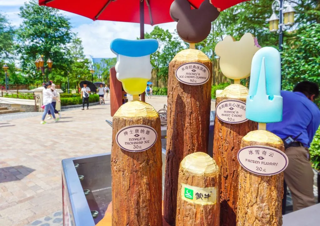 Shanghai Disneyland frozen ice cream treats on display at a snack cart.