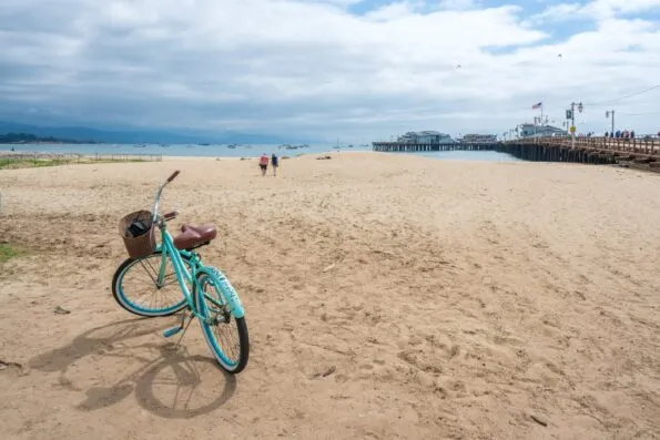 A blue bicycle on the sand of East Beach in Santa Barbara.