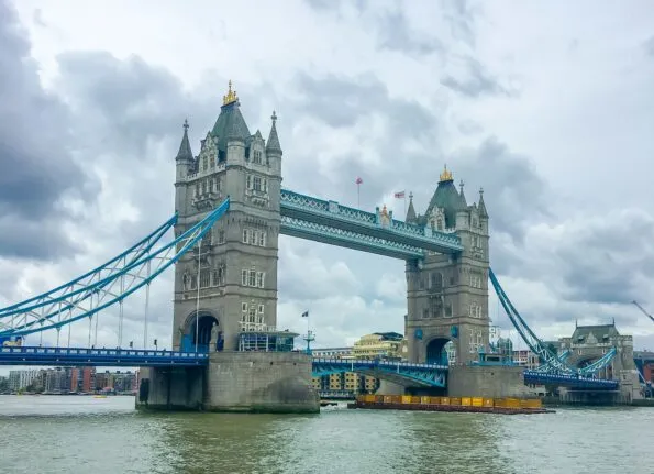 Harry Potter flies over the London Bridge on a broomstick.