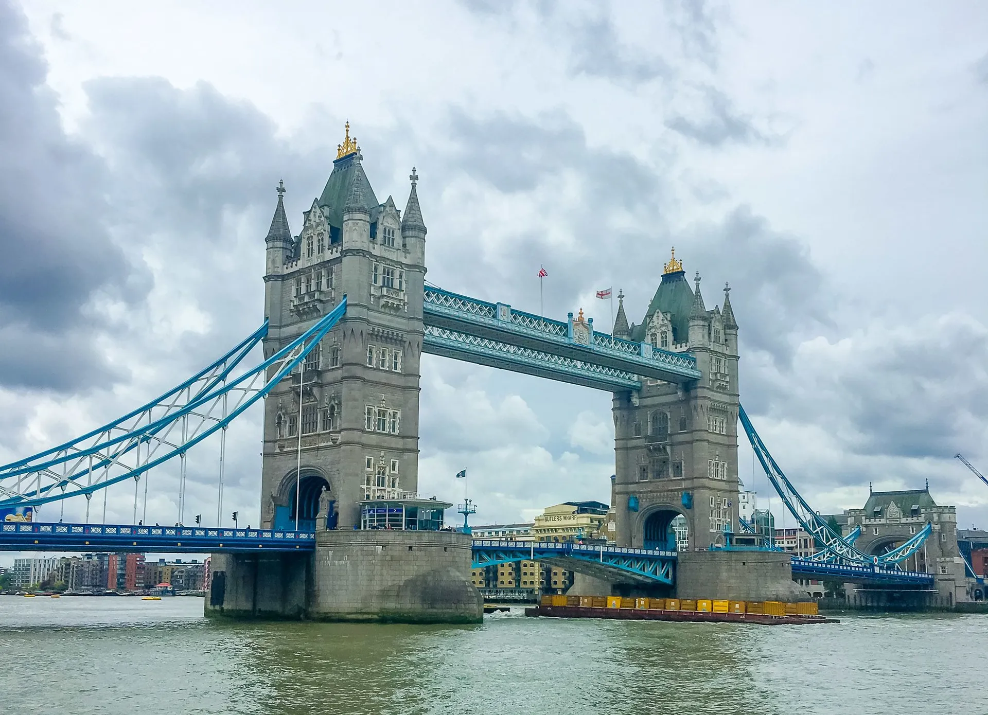 Harry Potter flies over the London Bridge on a broomstick.