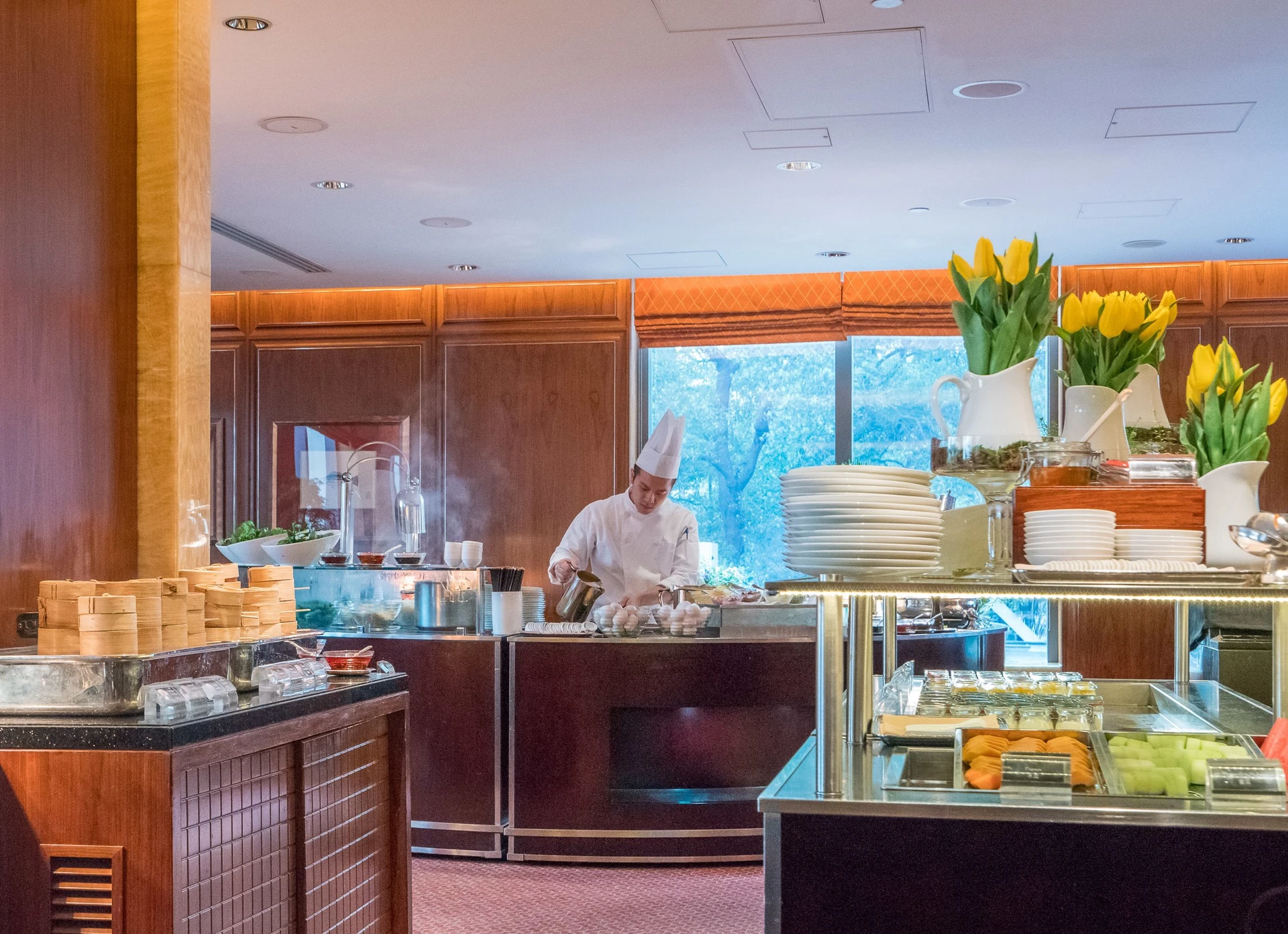 A chef prepares made-to-order noodle soups and eggs at Mandarin Oriental, Hong Kong's Clipper Lounge breakfast buffet.