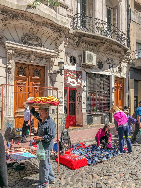 A vendor roams the San Telmo Fair in Buenos Aires selling snacks.