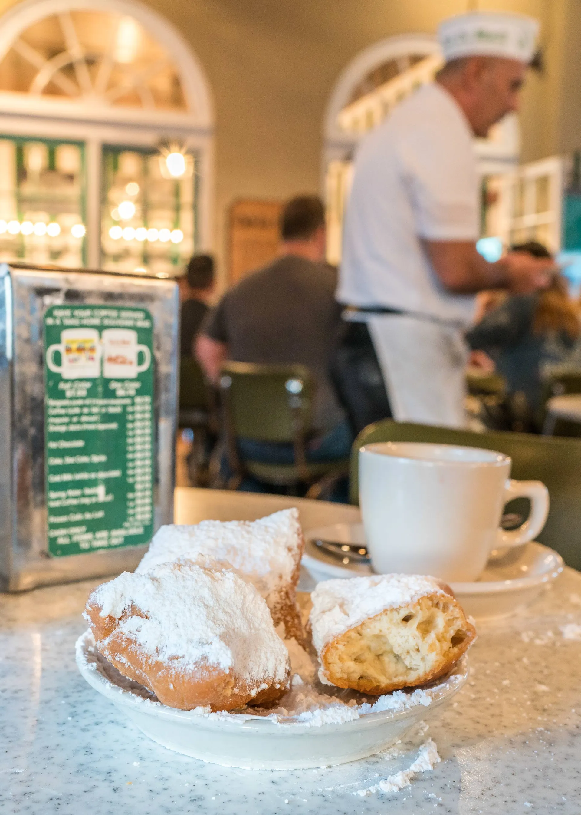 Beignets at Cafe du Monde are must-eat New Orleans foods.